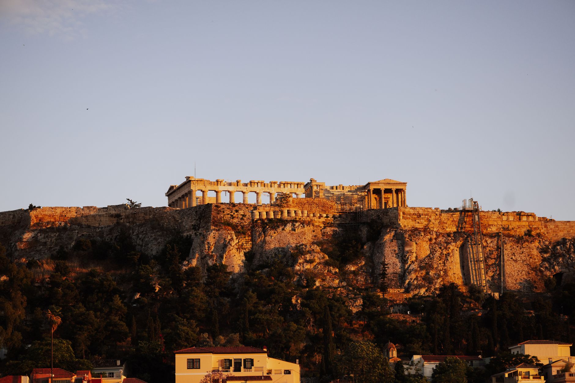 Golden hour view of the Parthenon atop the Acropolis in Athens, Greece.